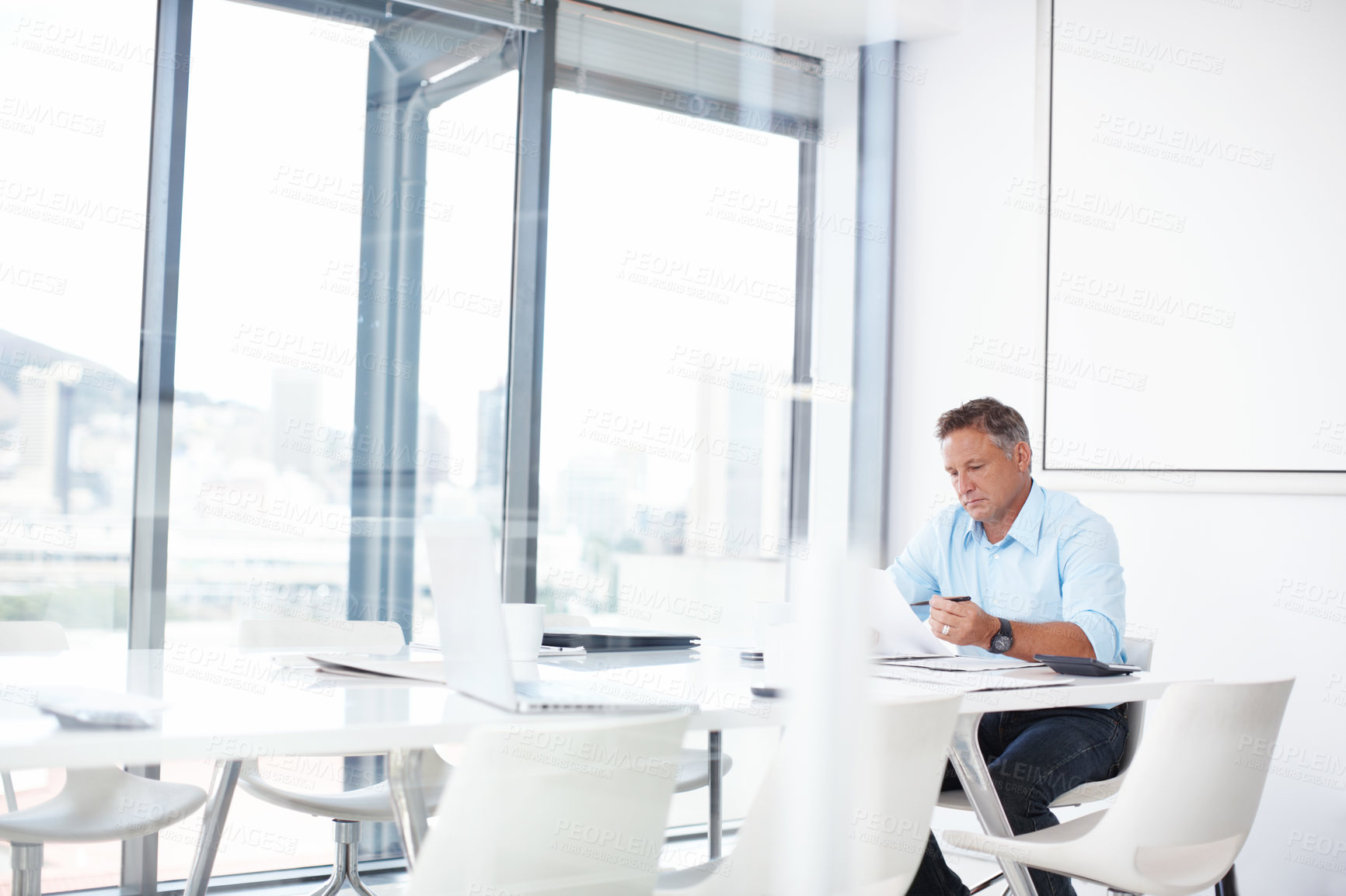 Buy stock photo A mature advertising executive thinking about his next ad campaign