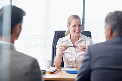 Buy stock photo A young business manager having a meeting with two colleagues in her office
