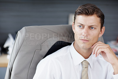 Buy stock photo A young executive lost in thought