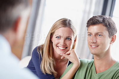 Buy stock photo A young couple getting expert advice from their financial advisor