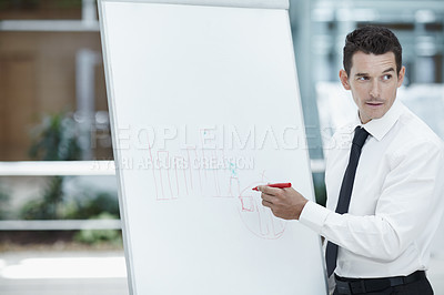 Buy stock photo Businessman writing on a flipchart
