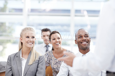 Buy stock photo Businesspeople listen to their colleague deliver a speech