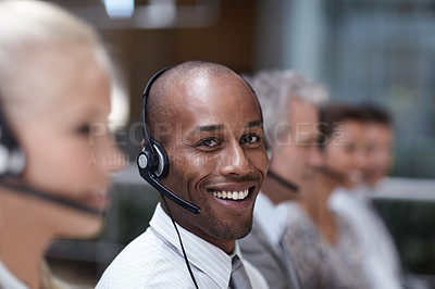 Buy stock photo Portrait of a handsome african american customer service representative talking into a headset