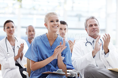 Buy stock photo Doctors and nurses applauding their lecturer
