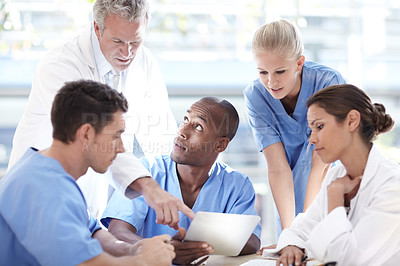 Buy stock photo A group of doctors having a discussion