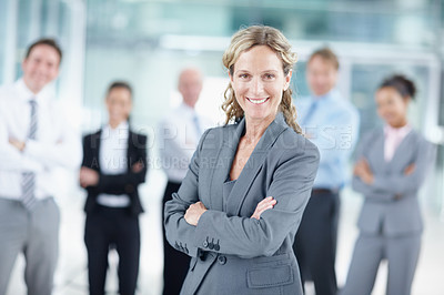 Buy stock photo Happy mature businesswoman with her business team behind her - portrait 