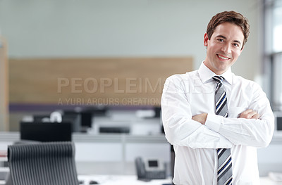 Buy stock photo Young business executive standing in the office looking confident with his arms crossed - portrait 