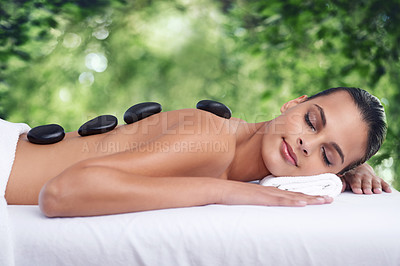 Buy stock photo Hot stone, massage and woman outdoor to relax, beauty and pamper back for wellness at luxury salon. Therapy, rocks and person in nature for skincare treatment, peace or calm for body health at spa