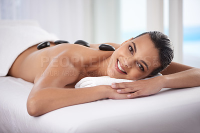 Buy stock photo Portrait, hot stone and woman with massage at spa for wellness, health and back treatment. Self care, cosmetic and young female person sleeping for warm stone back therapy at natural beauty salon.