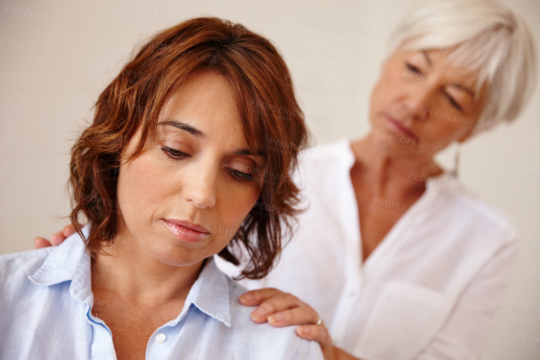 Buy stock photo Shot of a senior woman comforting her daughter who's going through a difficult time