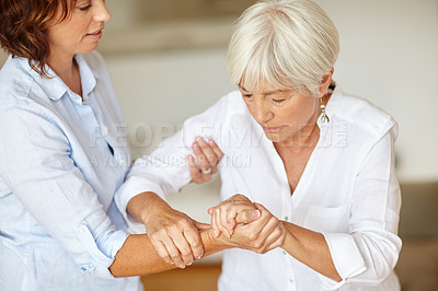Buy stock photo Shot of a woman assisting her elderly mother