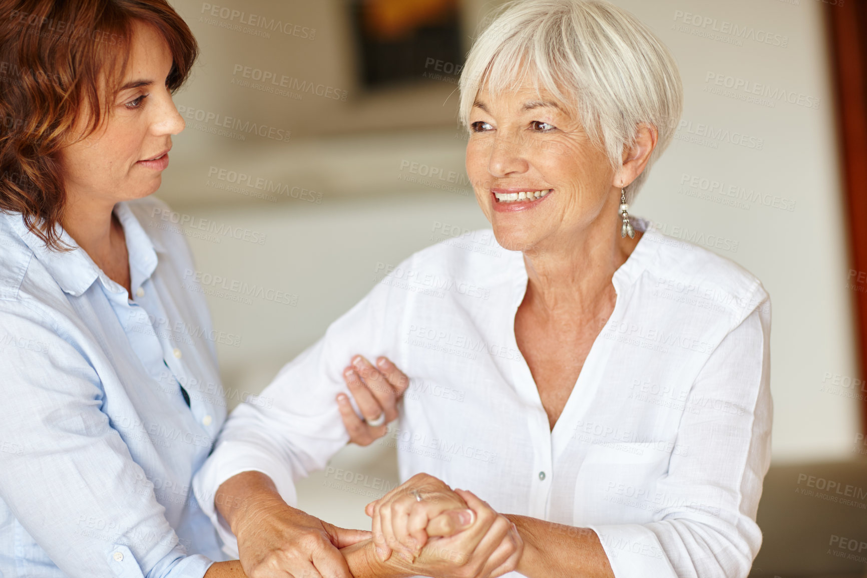 Buy stock photo Shot of a woman assisting her elderly mother