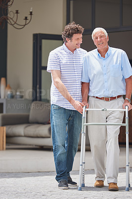 Buy stock photo Shot of a man assisting his elderly father with an orthopedic walker