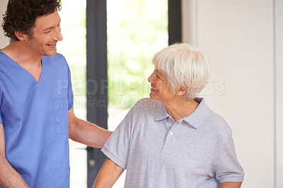 Buy stock photo Cropped shot of a male nurse checking on a senior patient