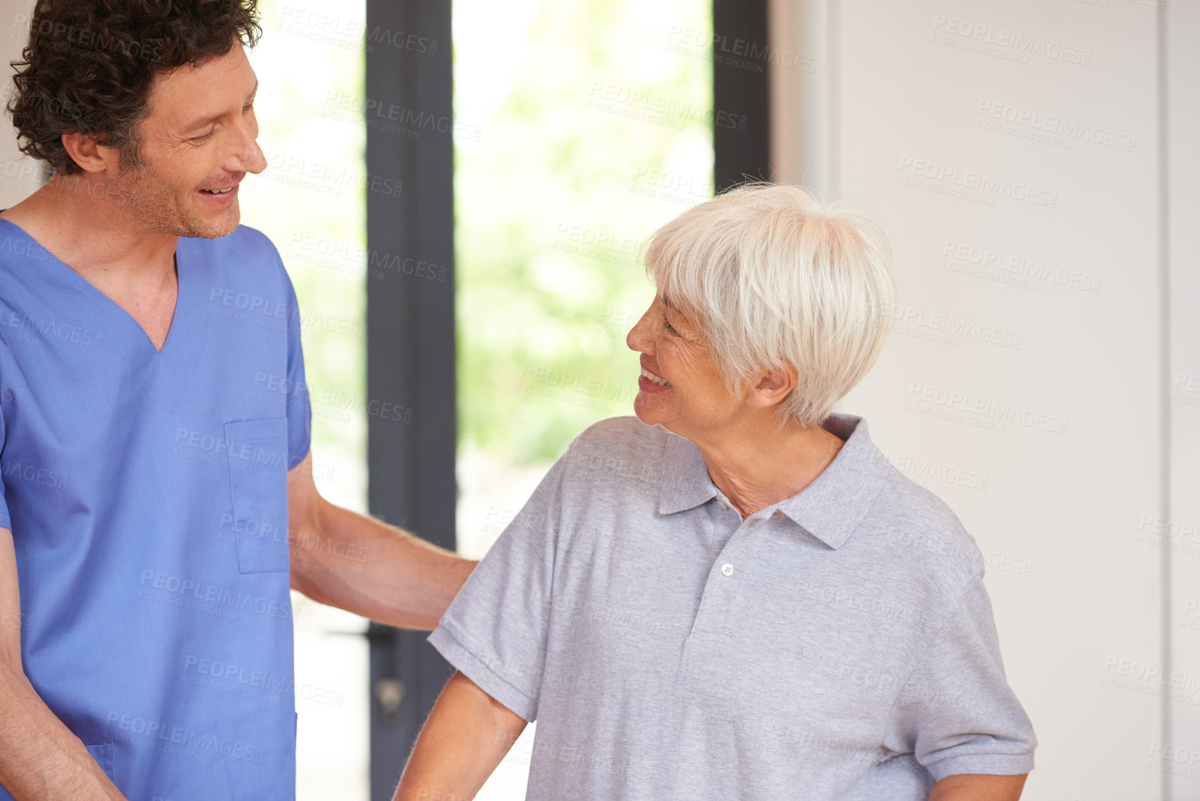 Buy stock photo Cropped shot of a male nurse checking on a senior patient