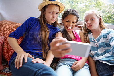 Buy stock photo Shot of a group of teenage friends taking a selfie together