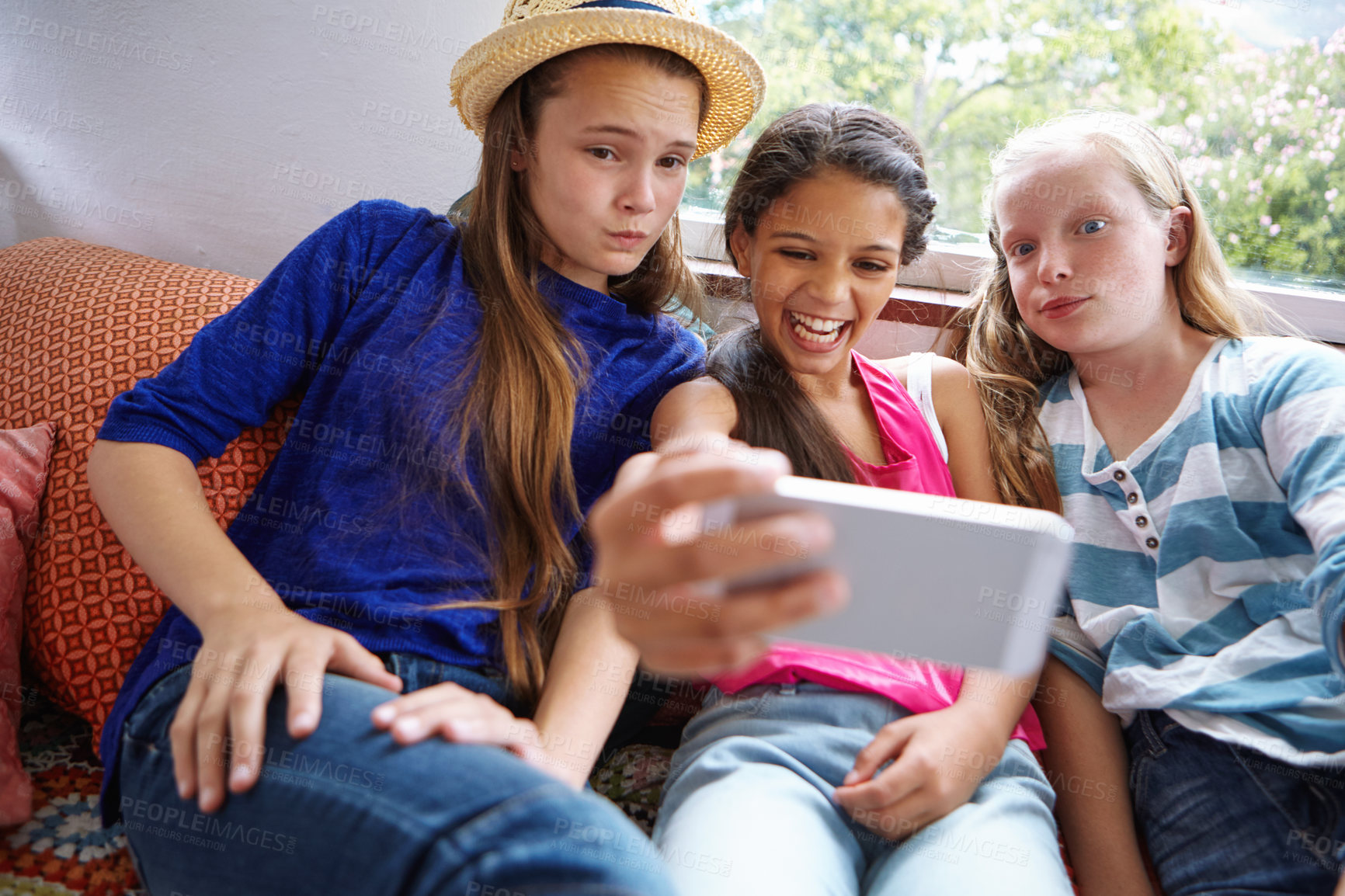 Buy stock photo Shot of a group of teenage friends taking a selfie together