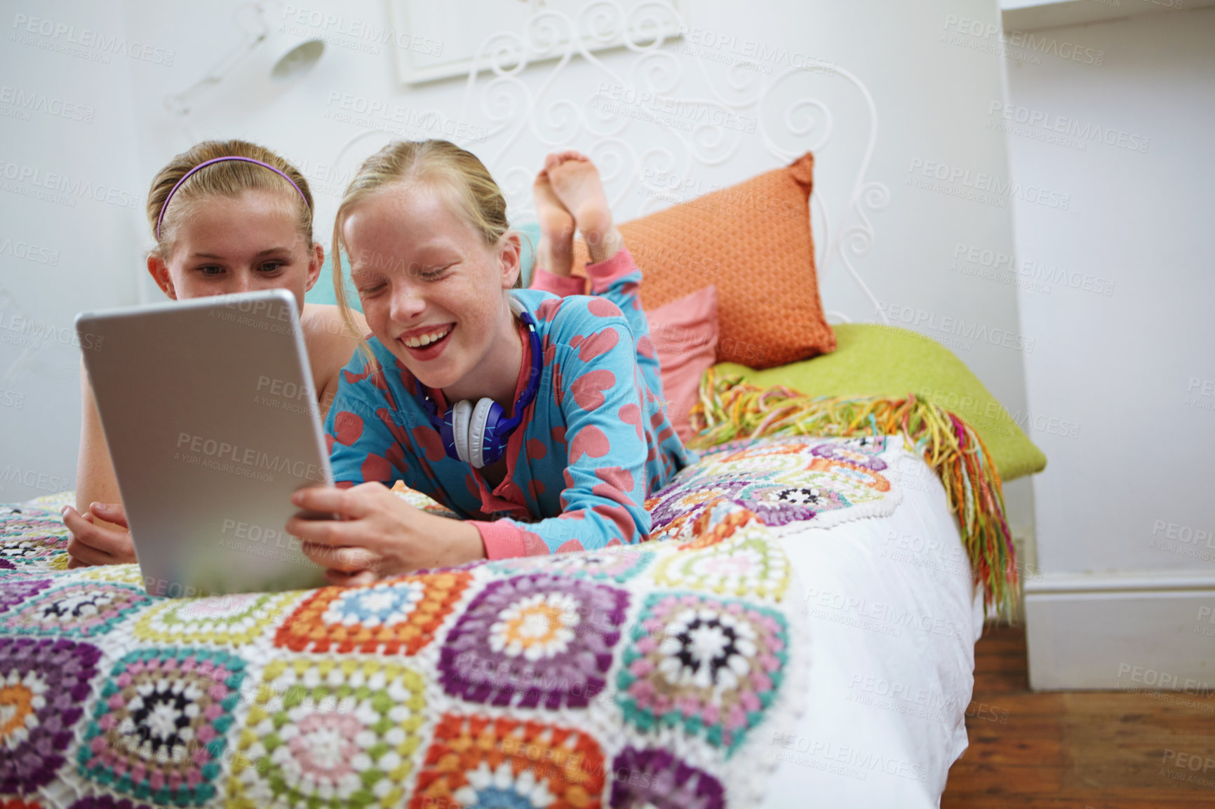 Buy stock photo Shot of a group of teenage friends using a digital tablet together