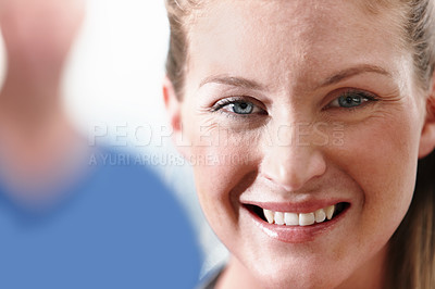Buy stock photo Closeup shot of a smiling young businesswoman with her co-workers in the background