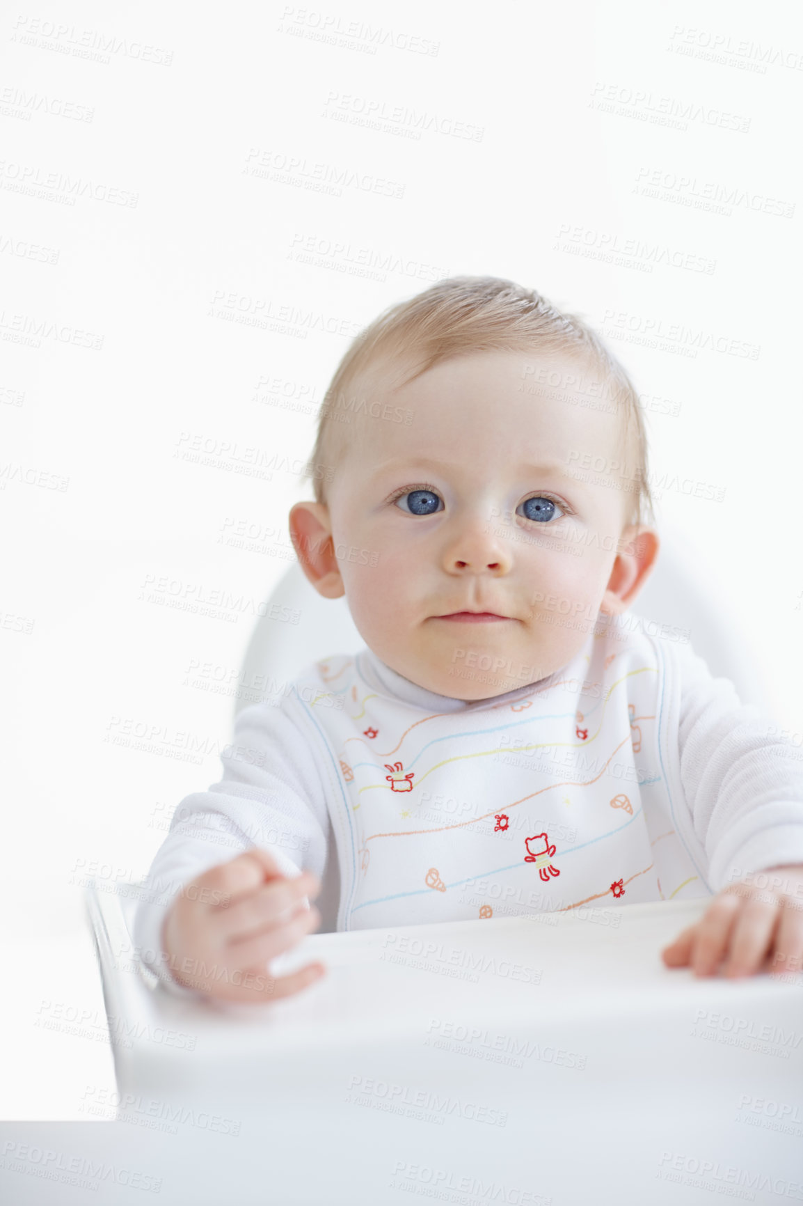 Buy stock photo A cute little baby boy sitting in his high chair