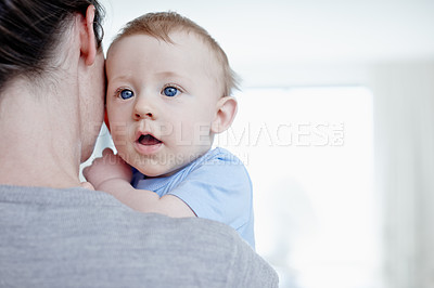 Buy stock photo Closeup of a baby boy looking over his mother's shoulder