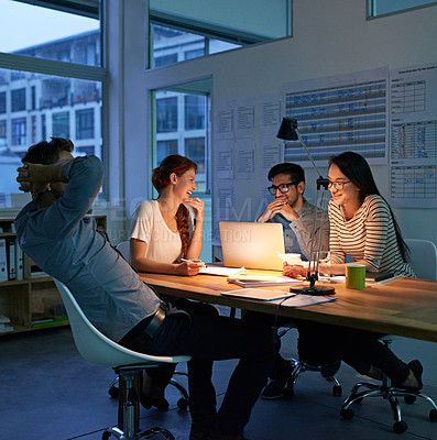 Buy stock photo Cropped shot of four colleagues working into the night