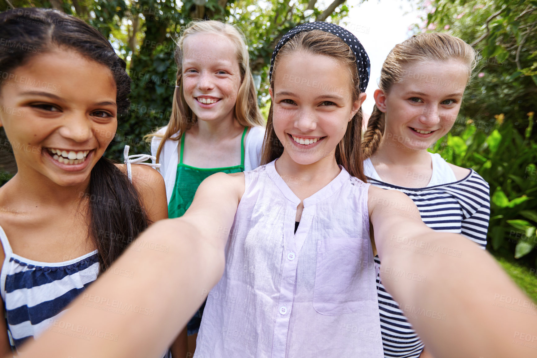 Buy stock photo Shot of a group of young girl friends taking a selfie together outside