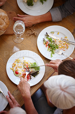 Buy stock photo High angle shot of a family sharing a meal together