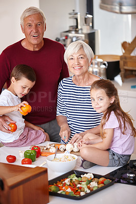 Buy stock photo Portrait of a grandparents preparing a meal with their grandchildren