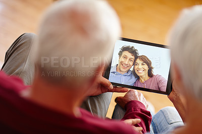 Buy stock photo Over the shoulder shot of a senior couple video calling their children