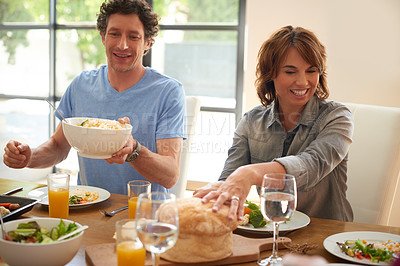 Buy stock photo Shot of a smiling couple having a meal together
