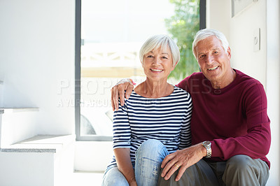 Buy stock photo Portrait of a loving senior couple sitting together at home