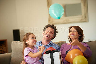 Buy stock photo Shot of a happy little girl celebrating her birthday with her family