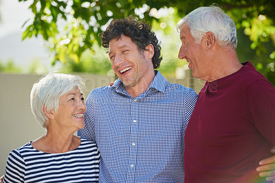 Buy stock photo Cropped shot of a senior couple standing outside with their son