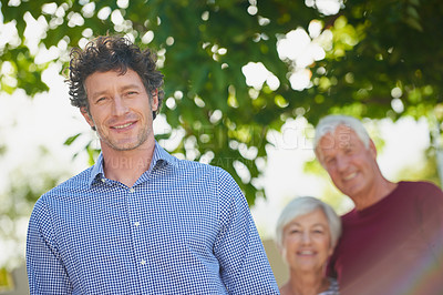 Buy stock photo Cropped portrait of a senior couple standing outside with their son