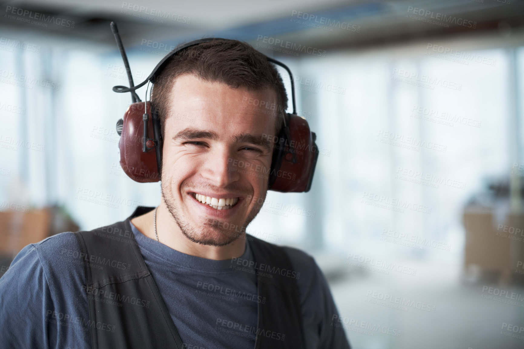 Buy stock photo Handsome young contractor standing on a construction site