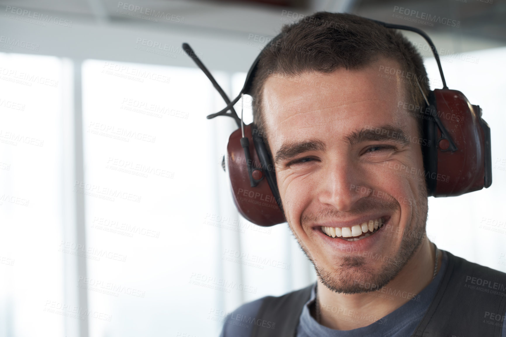 Buy stock photo Handsome young contractor standing on a construction site