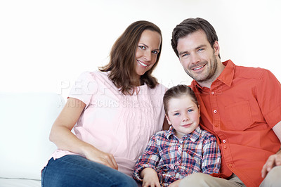 Buy stock photo Portrait of a young family of three sitting on the living room sofa