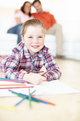 Buy stock photo A young girl enjoys colouring in