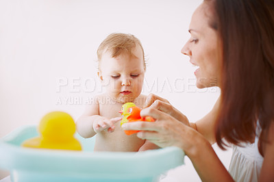 Buy stock photo A baby girl having fun in the bathtub with her new toys