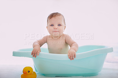 Buy stock photo A cute baby girl sitting happily in the bathtub