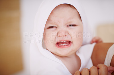 Buy stock photo A crying baby girl wrapped in a towel being held by her mother