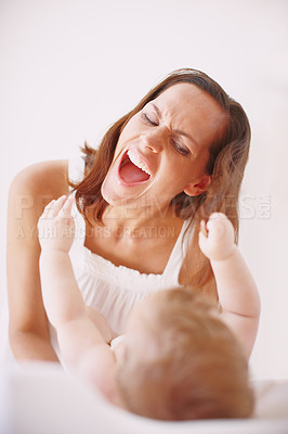 Buy stock photo A young mother showing her baby daughter affection