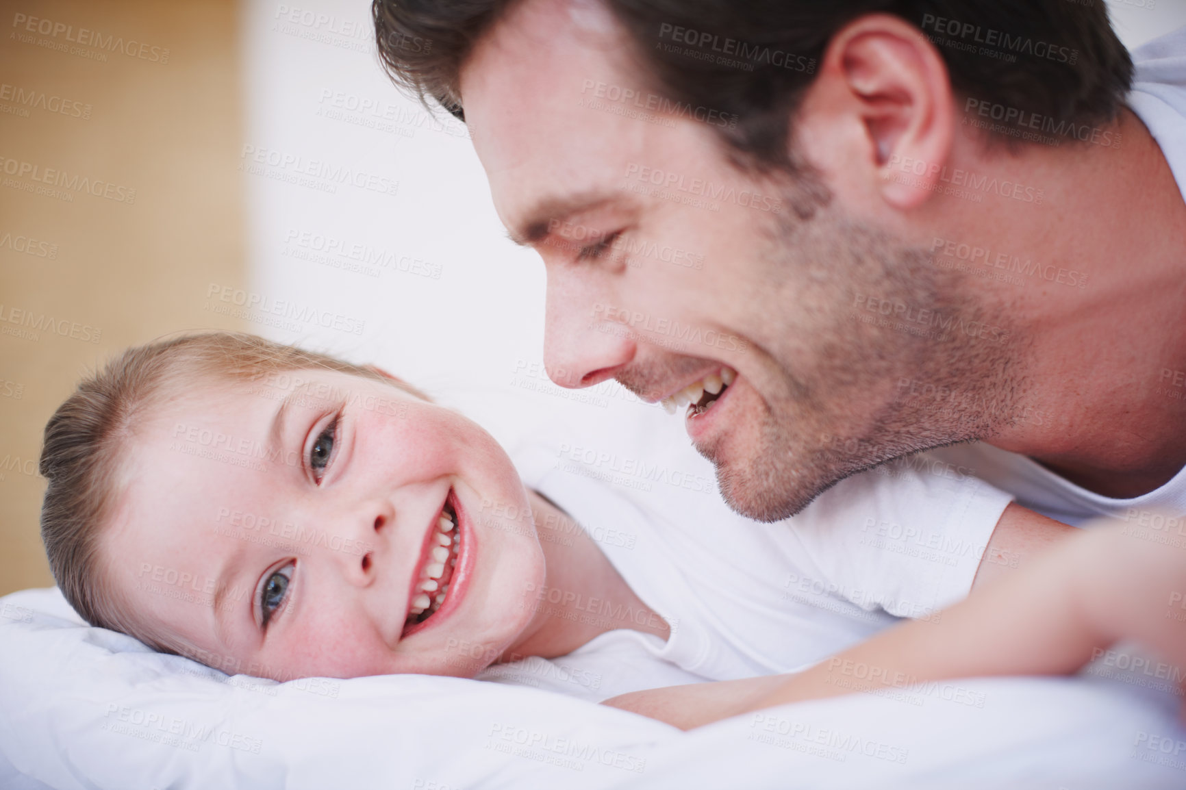 Buy stock photo A father and daughter being playful and affectionate indoors