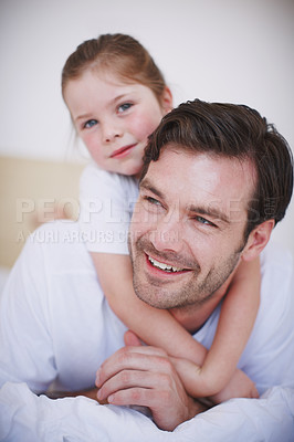 Buy stock photo Closeup of a little girl embracing her dad around the neck from behind