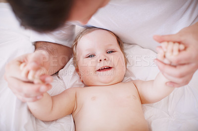 Buy stock photo A devoted young dad holding onto his baby daughter's hands
