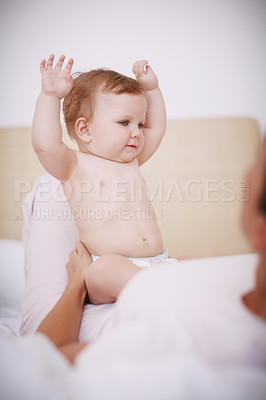 Buy stock photo A cute baby girl having fun while sitting with her mother