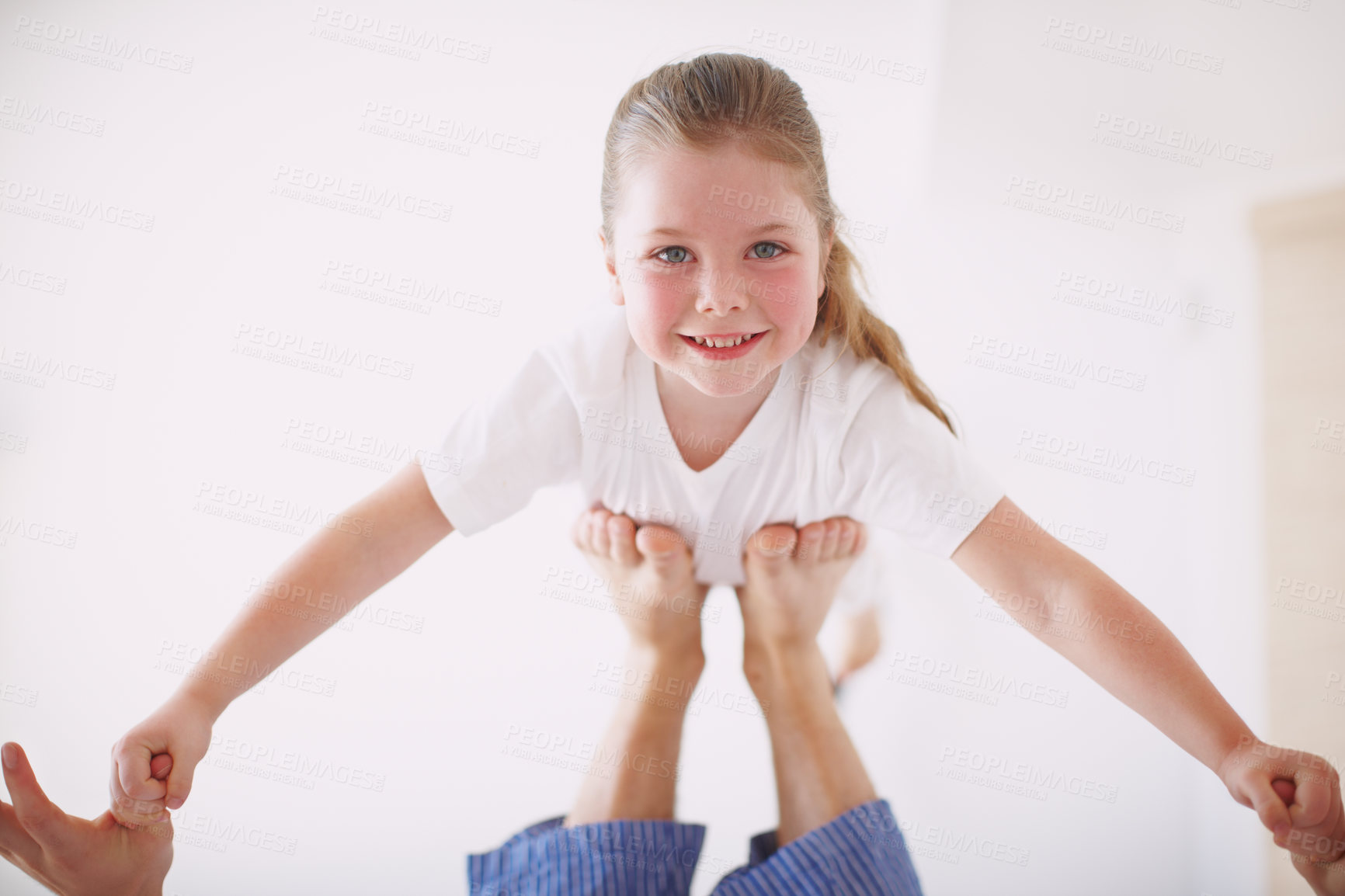 Buy stock photo Portrait of a young girl propped up on her father's feet