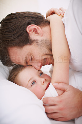 Buy stock photo A dad putting his daughter to bed