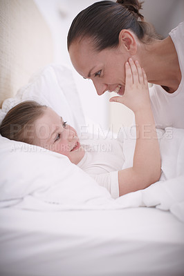 Buy stock photo A mother saying goodnight to her young daughter